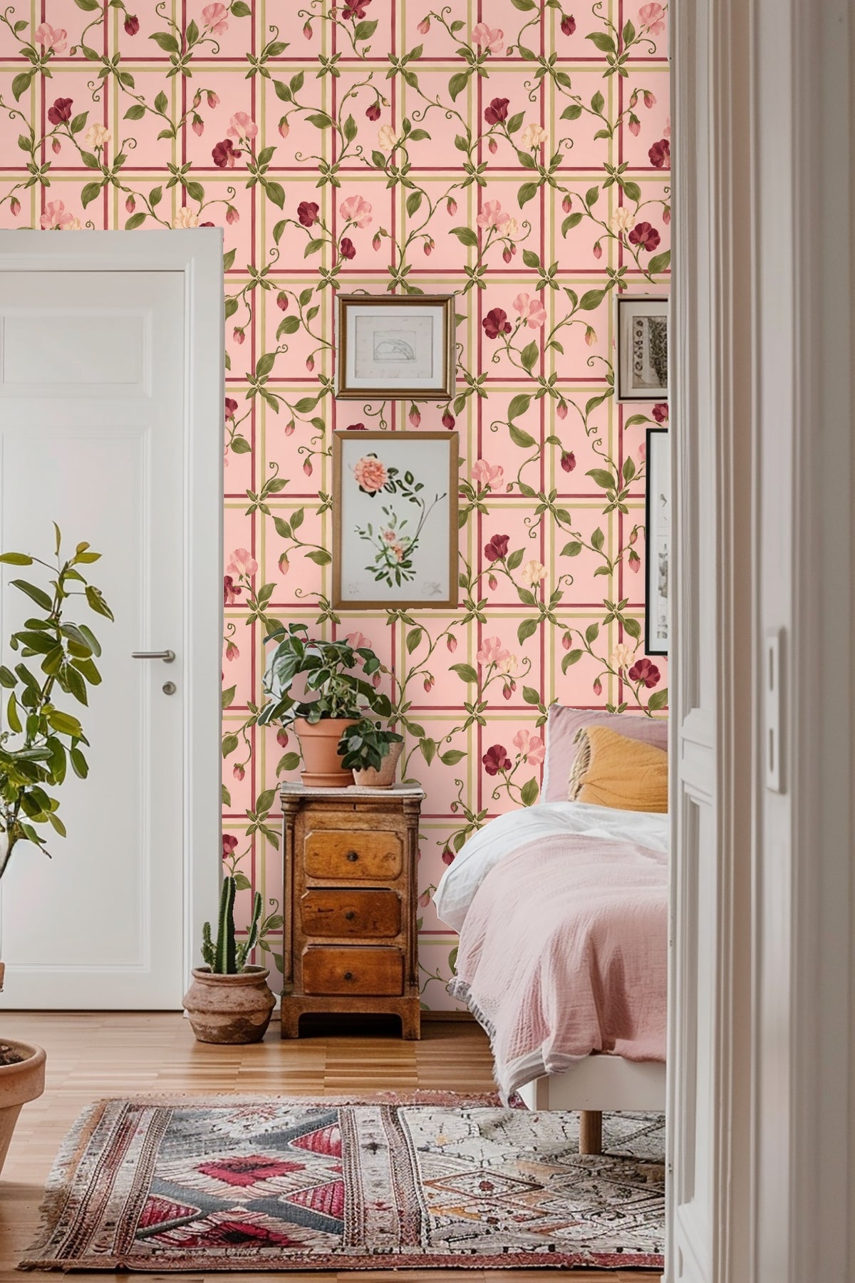 Side view of floral wallpaper behind white ceramic vase and wooden table
