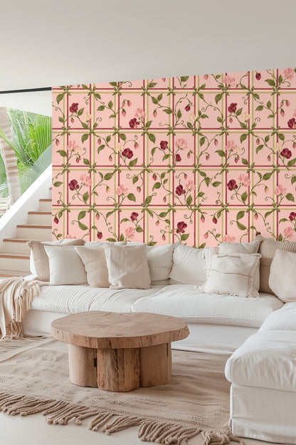 Bedroom with soft pink floral lattice wallpaper behind velvet peach headboard and cushions
