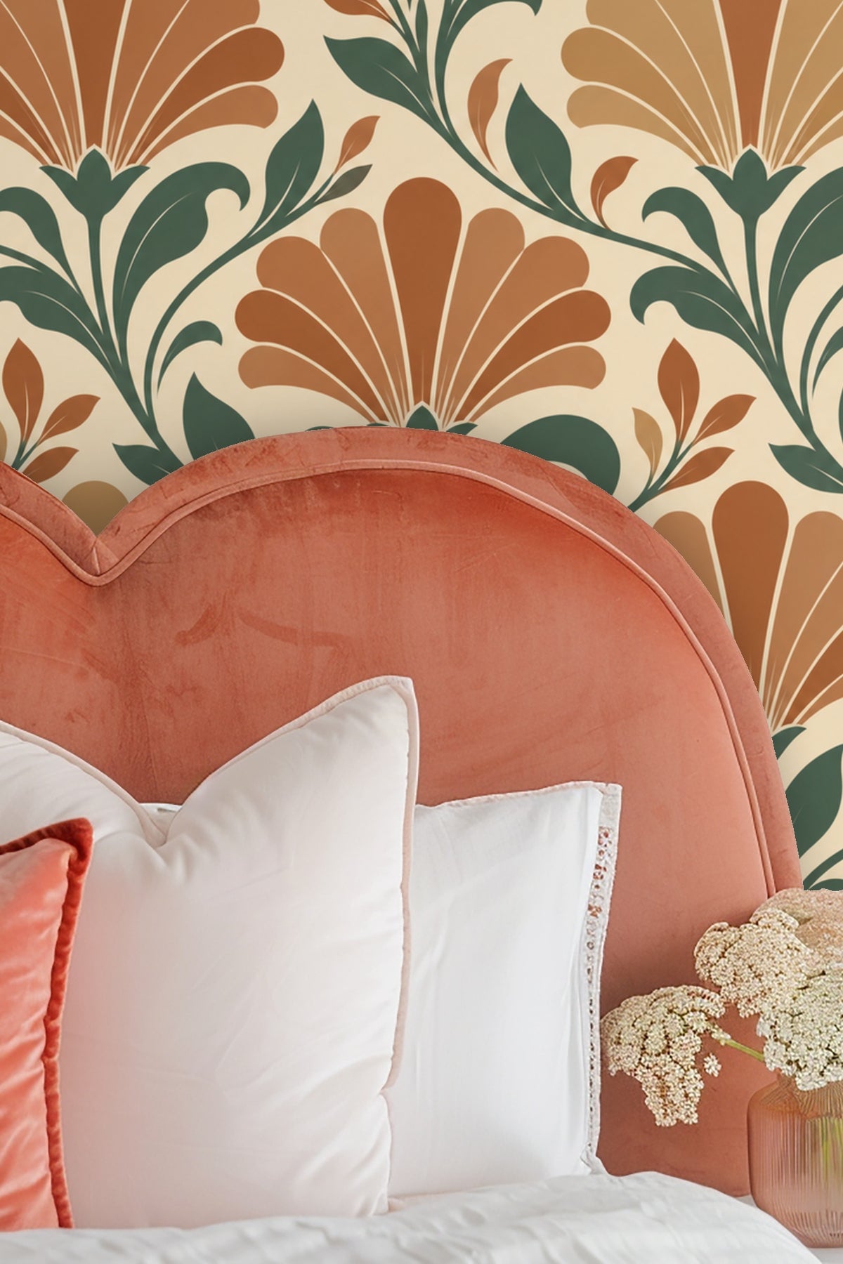 Partial view of wallpaper next to a bed with a green headboard and assorted cushions