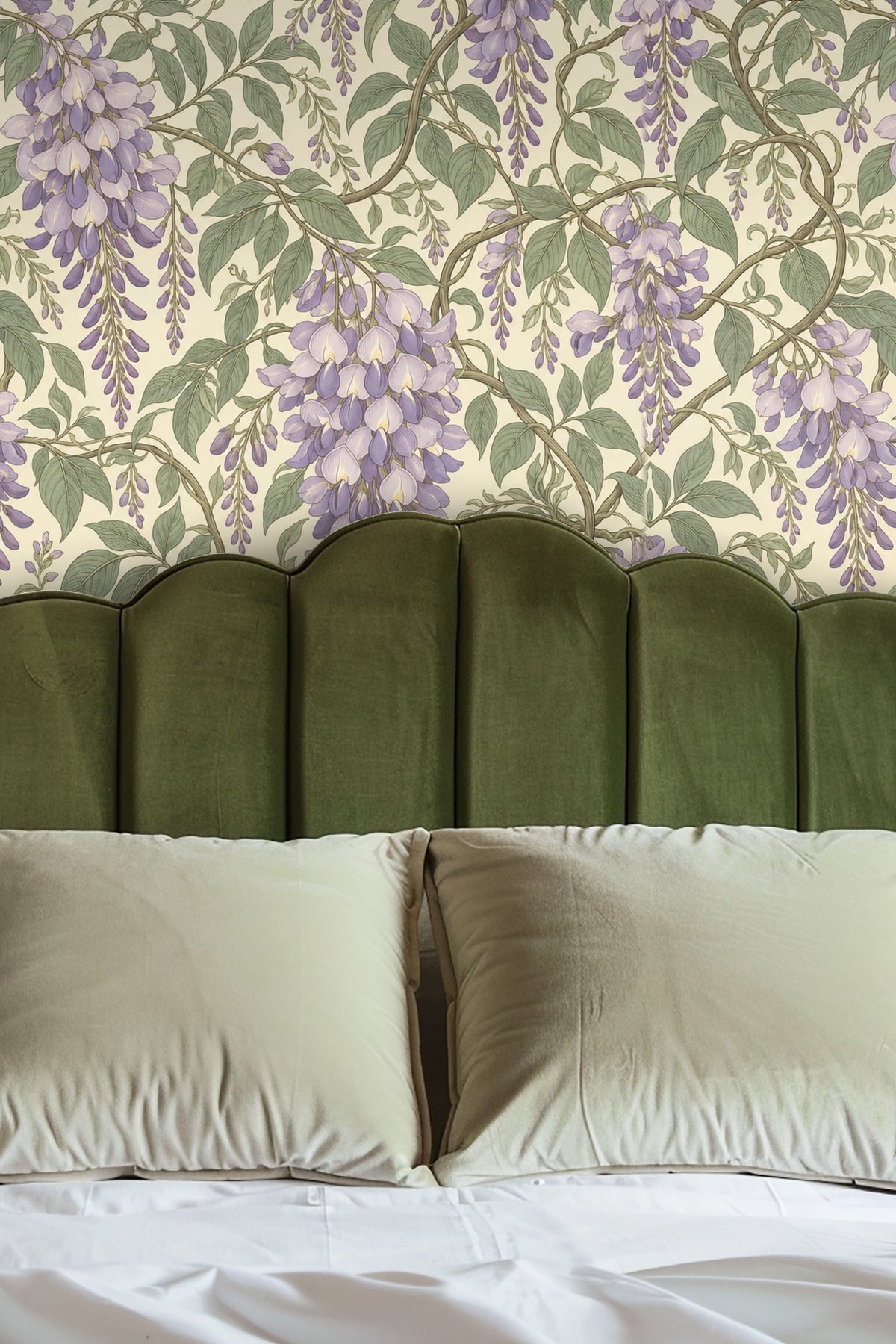 Close-up of Wisteria Cascade wallpaper with a lit cream candle and glass vase holding white baby's breath flowers on a wooden surface