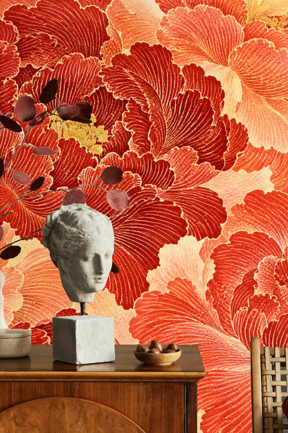 Living room wall showing bold cinnabar floral wallpaper with beige sectional sofa and gold accents
