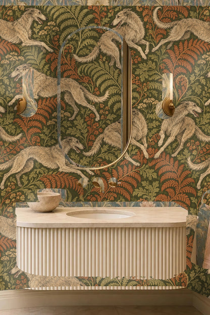 Side view of a living room wall with Borzoi Fern Dance wallpaper and natural light casting shadows