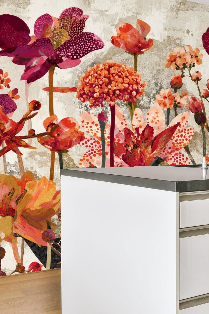 Room with wallpaper showing large red and orange floral pattern behind a rattan basket with toys on a light floor.