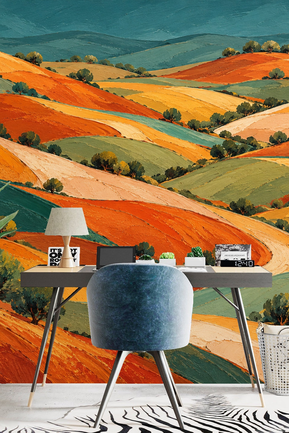 Living room with curved chairs against a vibrant patchwork hills wallpaper in warm earth tones.