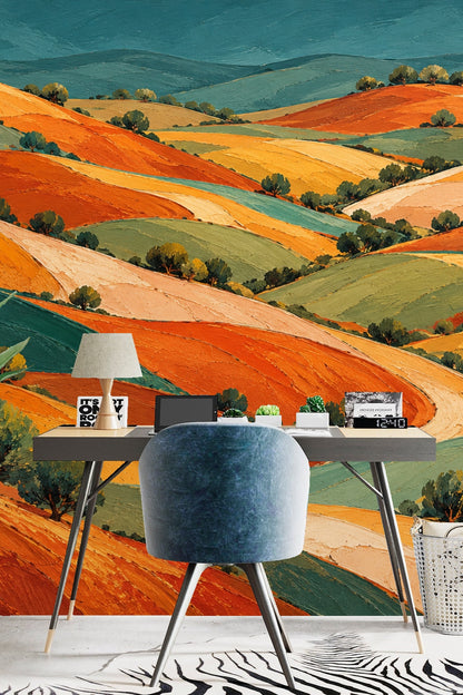 Living room with curved chairs against a vibrant patchwork hills wallpaper in warm earth tones.