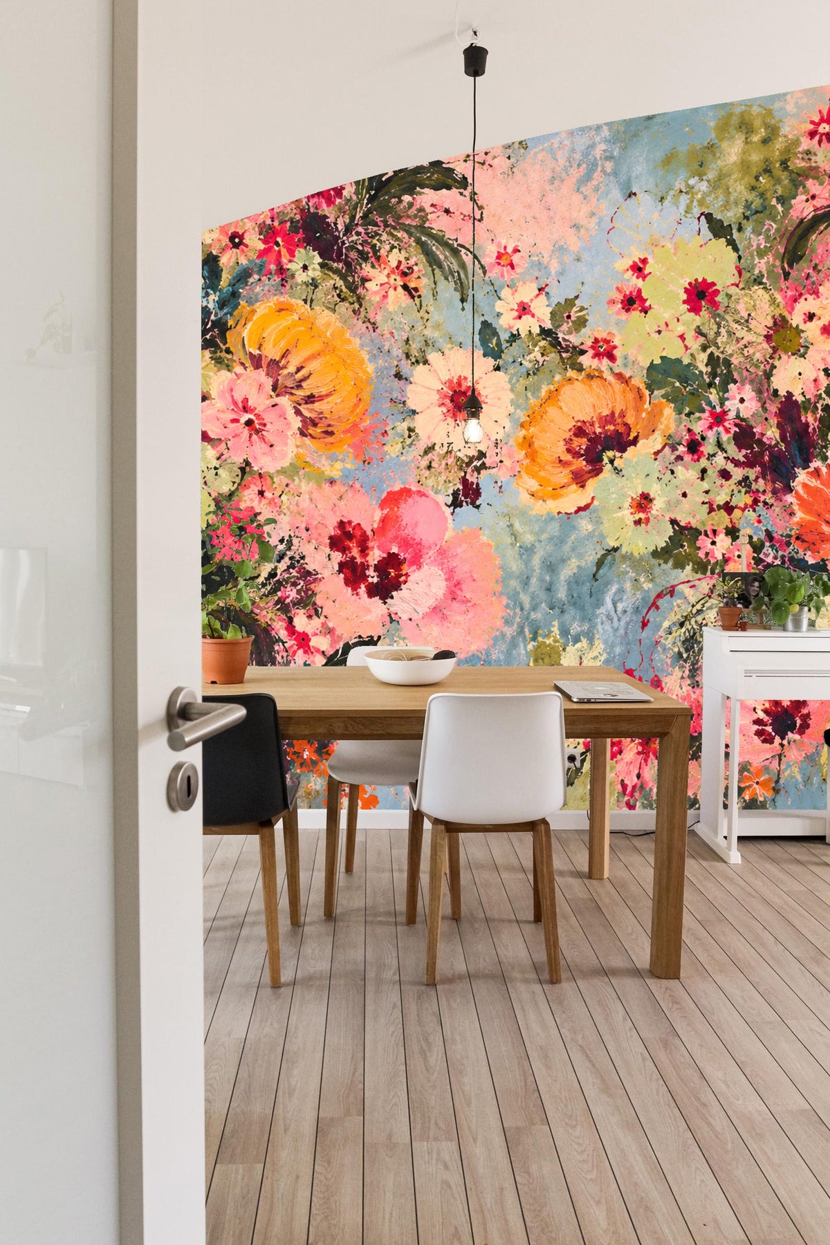 Children's room corner showing coral and pink floral wallpaper and a plush octopus stool.