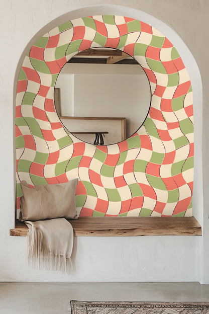 Detail of wavy checkerboard tiles in muted coral and sage on cream background.