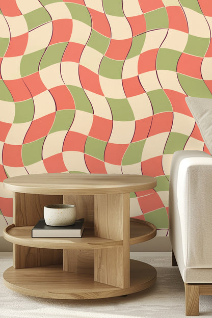 Close-up of mustard yellow velvet headboard against wavy coral, cream, and sage checkerboard wallpaper.