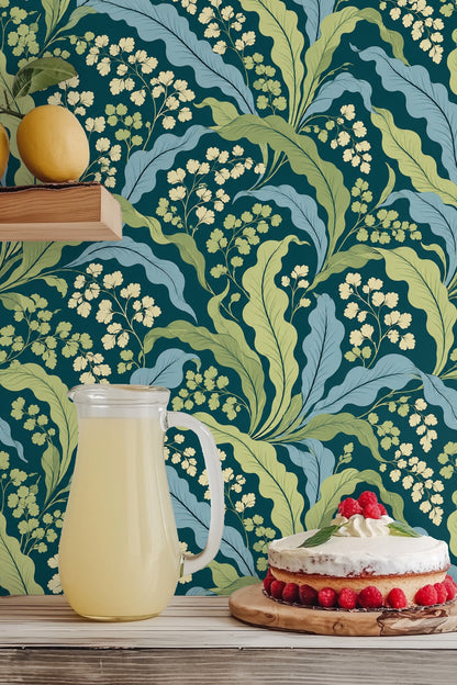 Textured wall surface covered with teal background and painterly leaves pattern