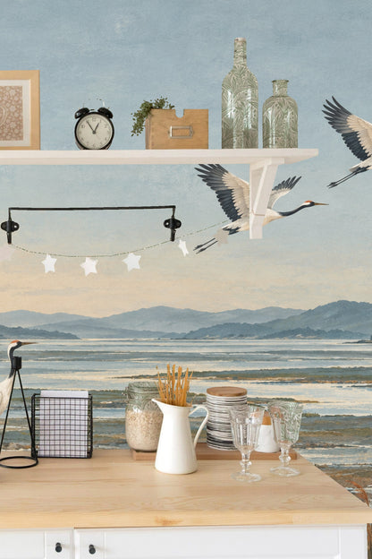 Flock of three cranes flying in diagonal line upward across the mural.