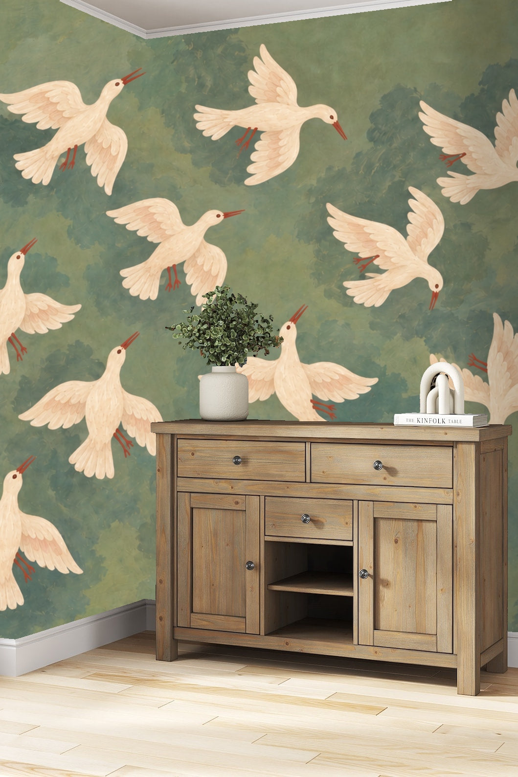 Nursery room with crib and armchair, walls adorned with wallpaper depicting white doves flying in a muted green-blue sky