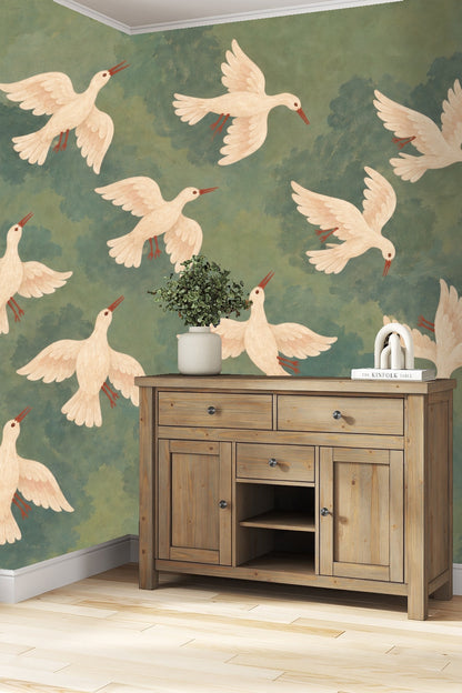 Nursery room with crib and armchair, walls adorned with wallpaper depicting white doves flying in a muted green-blue sky