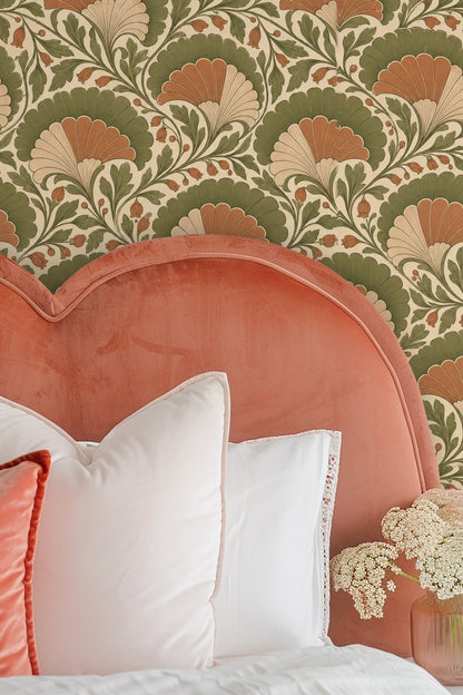 Partial view of high-back green velvet headboard against wallpaper