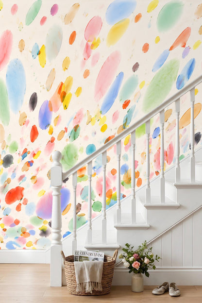 Modern interior featuring lively, playful watercolor wallpaper behind neutral furniture.