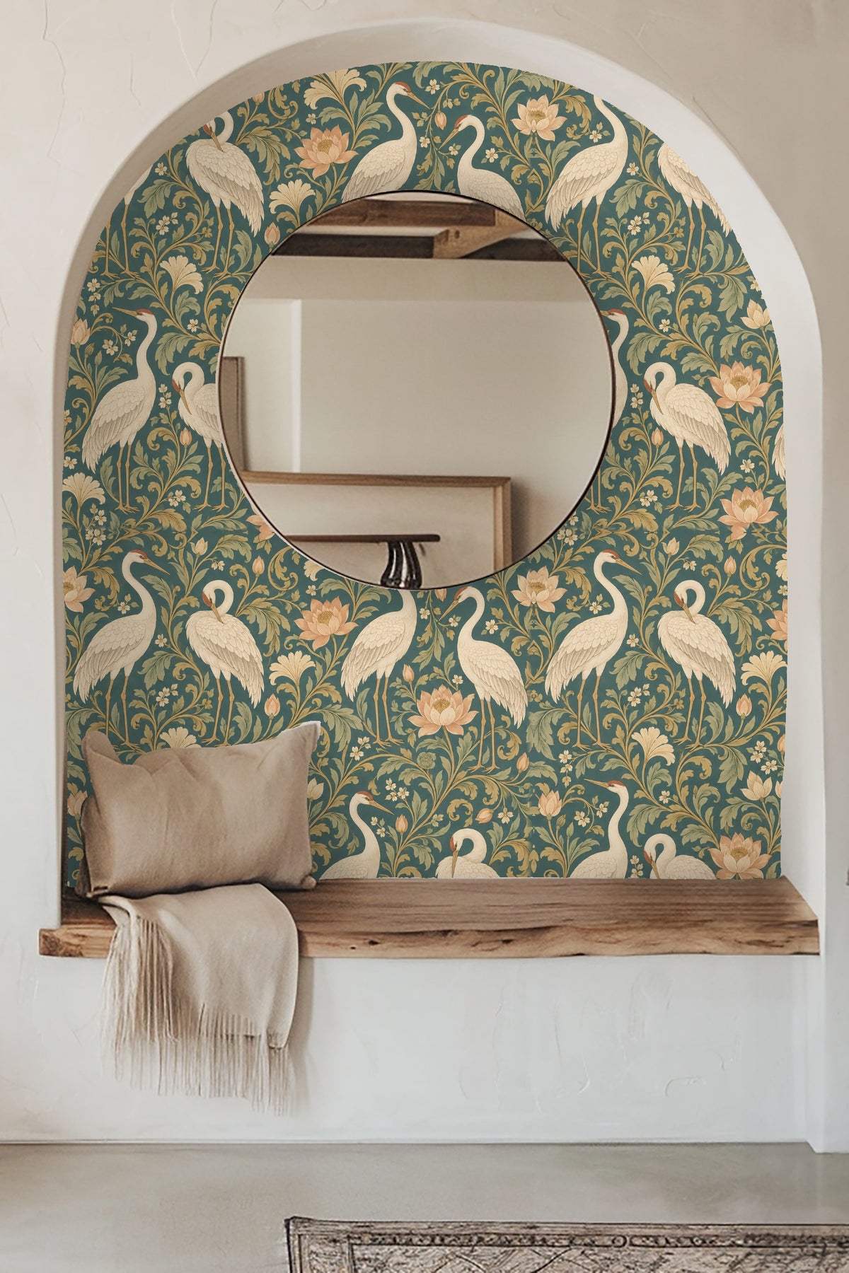 Close-up interior shot of green velvet headboard against wallpaper with ivory cranes and peach lotuses