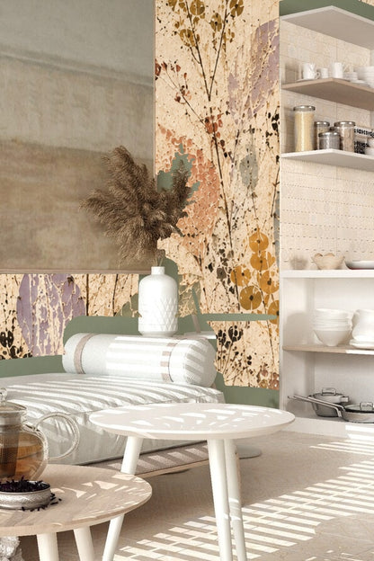 Close-up view of wallpaper pattern showing layered leaves in faded green, lavender, gold, and coral hues
