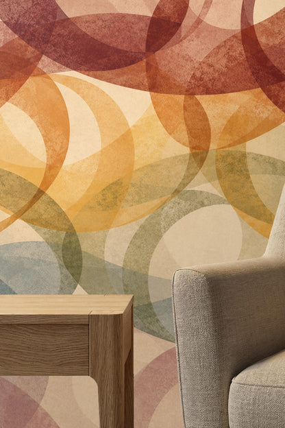 Room scene with exposed layered elliptical pattern wall in muted colors pairing with simple natural furniture
