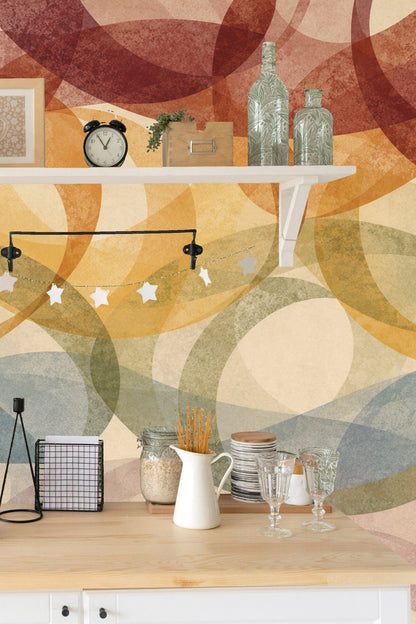 Overlapping midcentury-inspired ring shapes in warm browns, oranges, and subtle blues with a creamy base