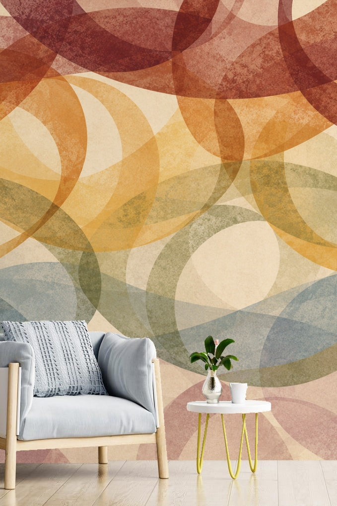 Light blue armchair and small white table with plant against muted blue, olive, and terracotta overlapping loops wallpaper