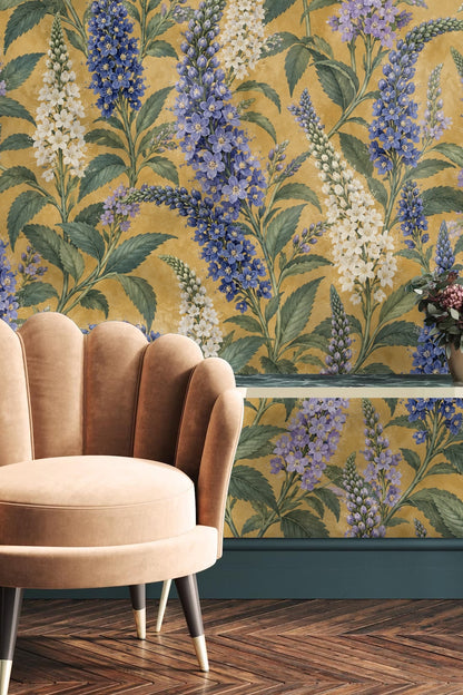 Room corner showing wallpaper with cobalt floral spikes on mustard background continuing around the wall.