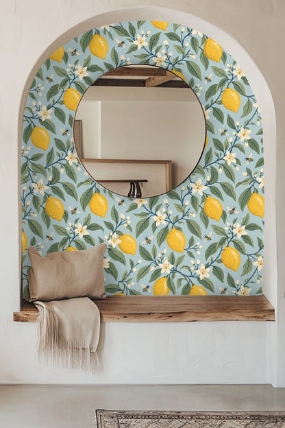 living room wall decorated with lemon and floral wallpaper behind light wood coffee table