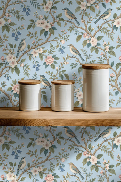 Soft bluebirds perched delicately on branches within the wallpaper design