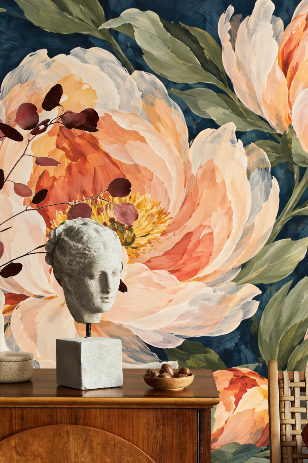 Peony Bloom on Indigo wallpaper covering an accent wall behind a beige sectional sofa and gold coffee table in a living room