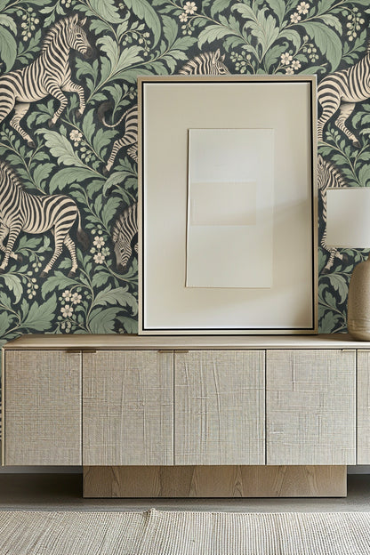 Living room with wallpaper showing striped zebras and large green leaves behind sideboard and framed art