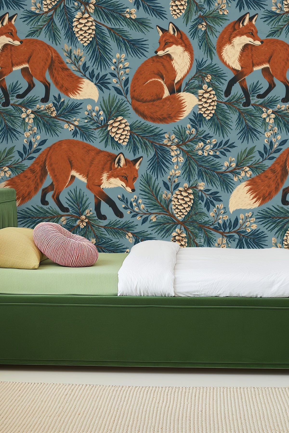 Hand holding a fox and pinecone patterned wallpaper sample on white paper background.