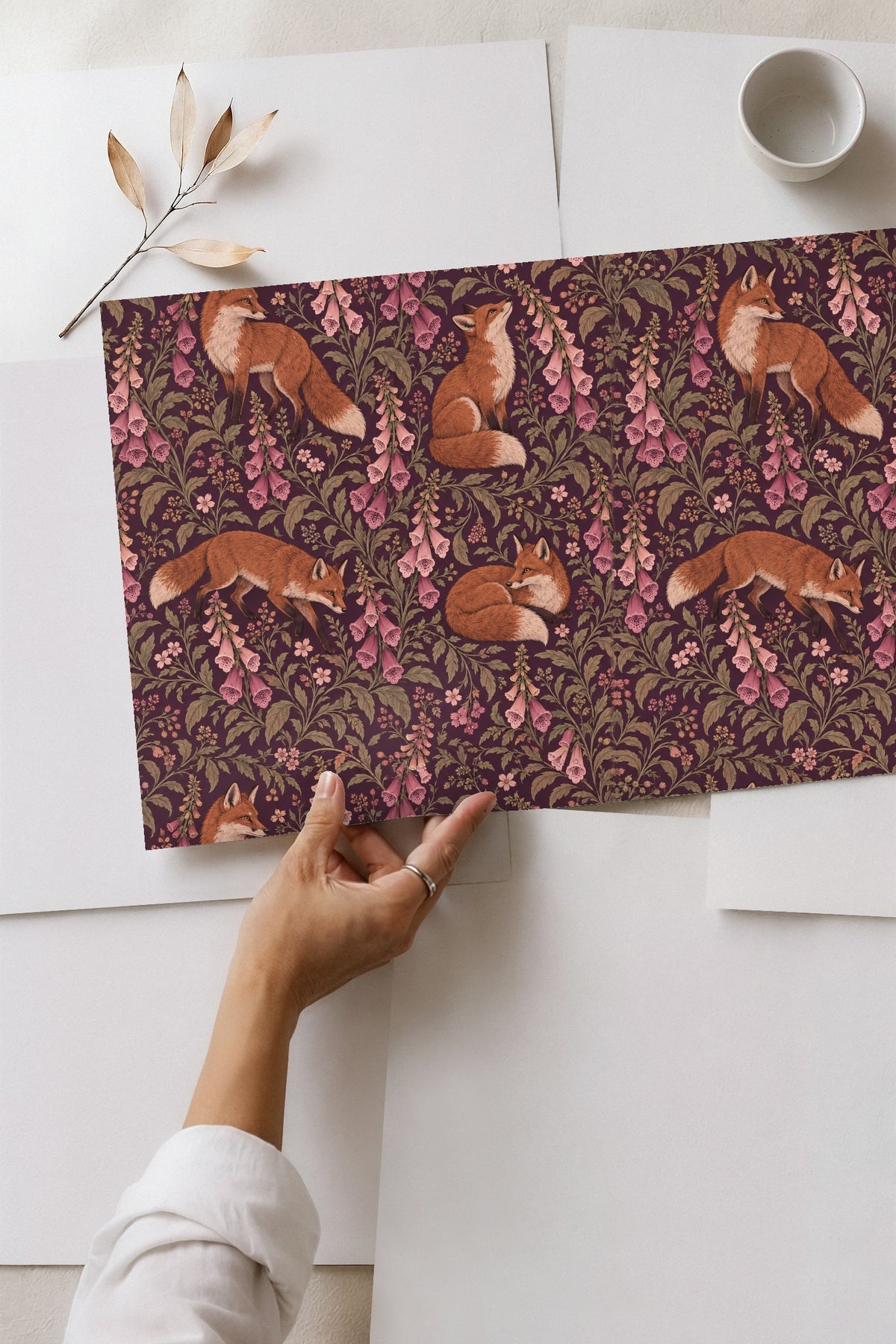 Repeating pattern of fox tails and floral elements