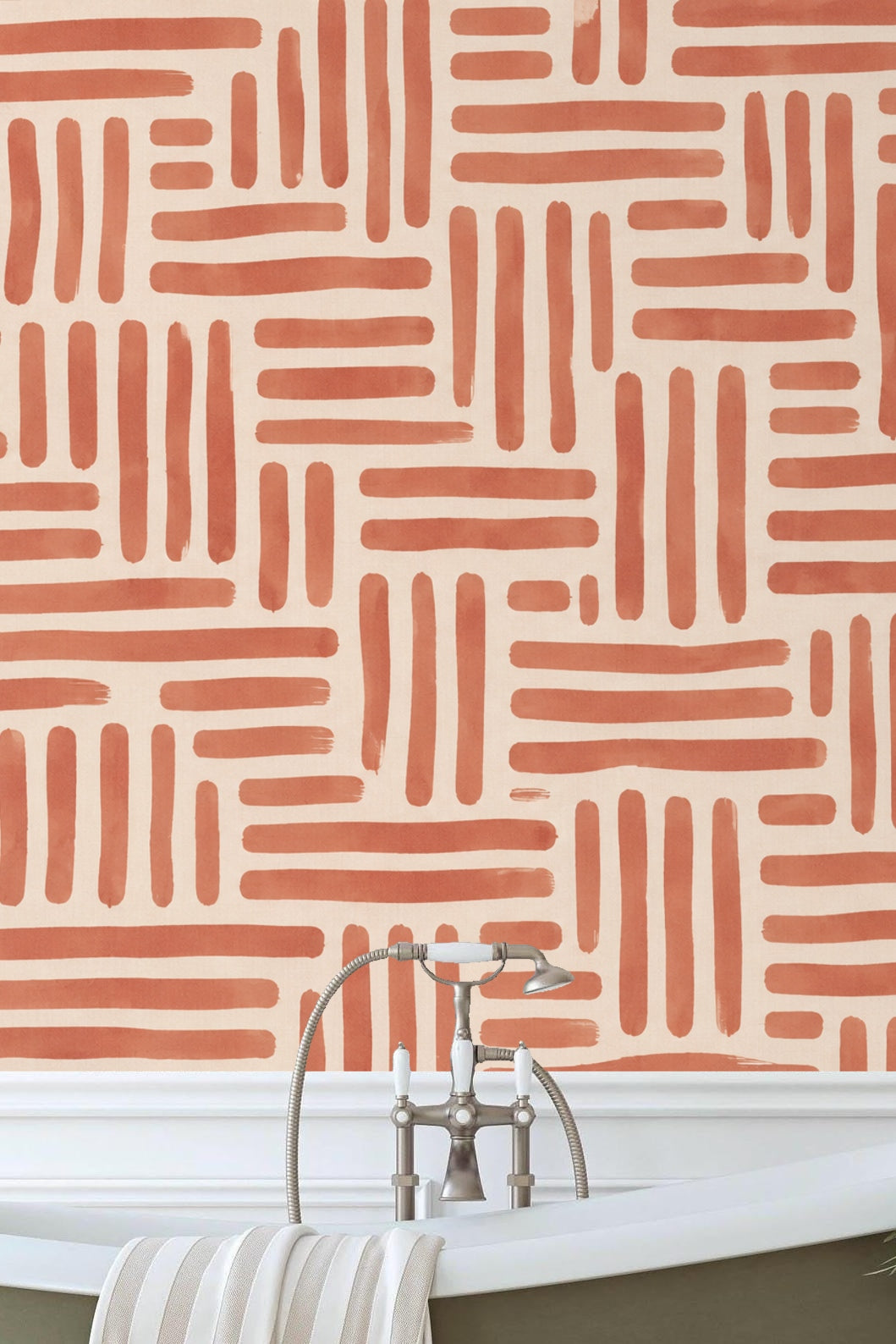White bookshelf and soft toys in a child's room with terracotta linear wallpaper backdrop