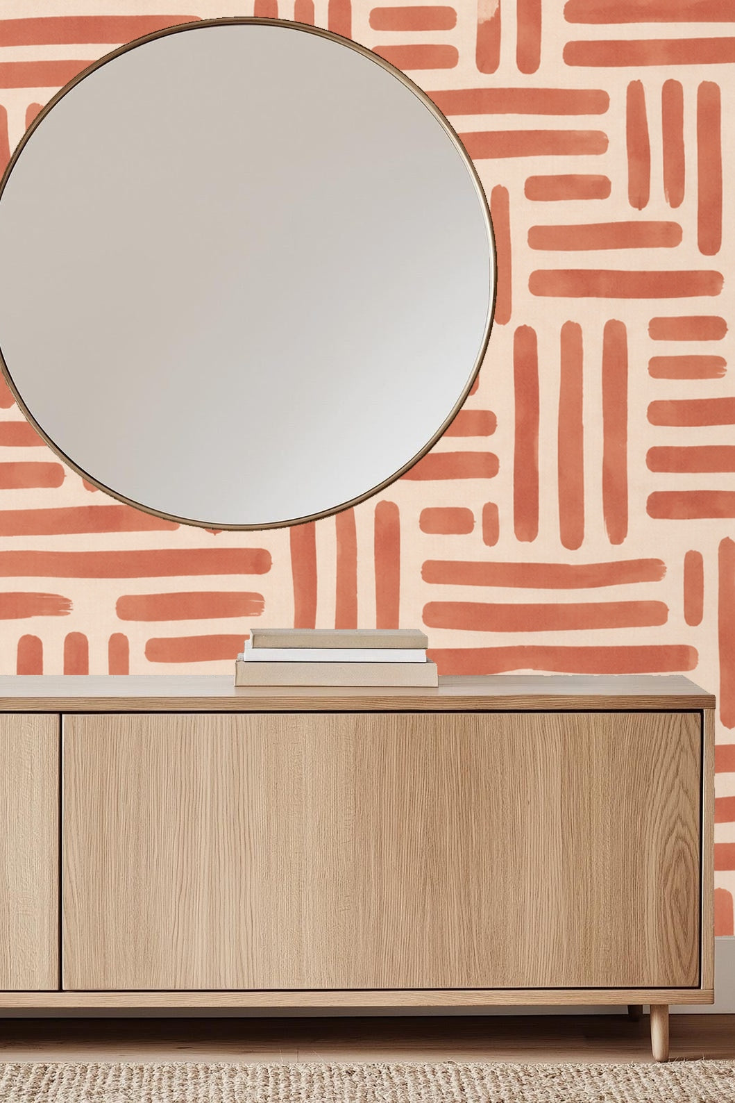 Cozy corner with cushion and terracotta wall pattern behind a light wooden frame chair
