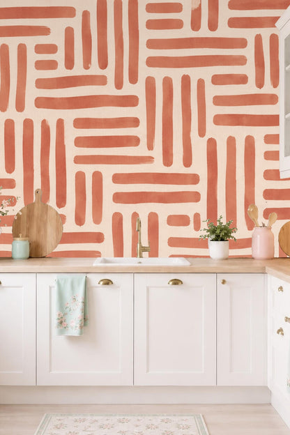 Close-up of wallpaper showing imperfect brushstroke edges in terracotta tone