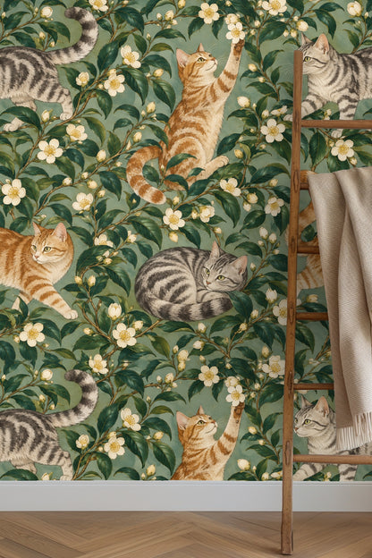 Detailed botanical wallpaper imagery with two gray cats and two orange cats intertwined among camellia blooms.