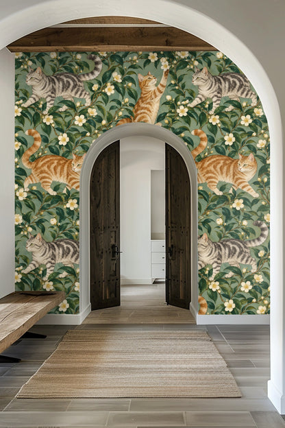 Wallpaper artwork showing tabby cats playfully positioned among lush green camellia branches with white blossoms on a teal background.
