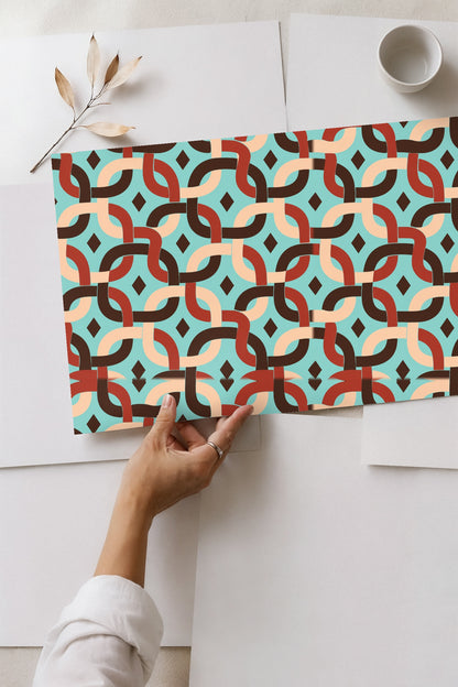 Close-up detail of interwoven curved bands in brown, rust, and beige on aqua