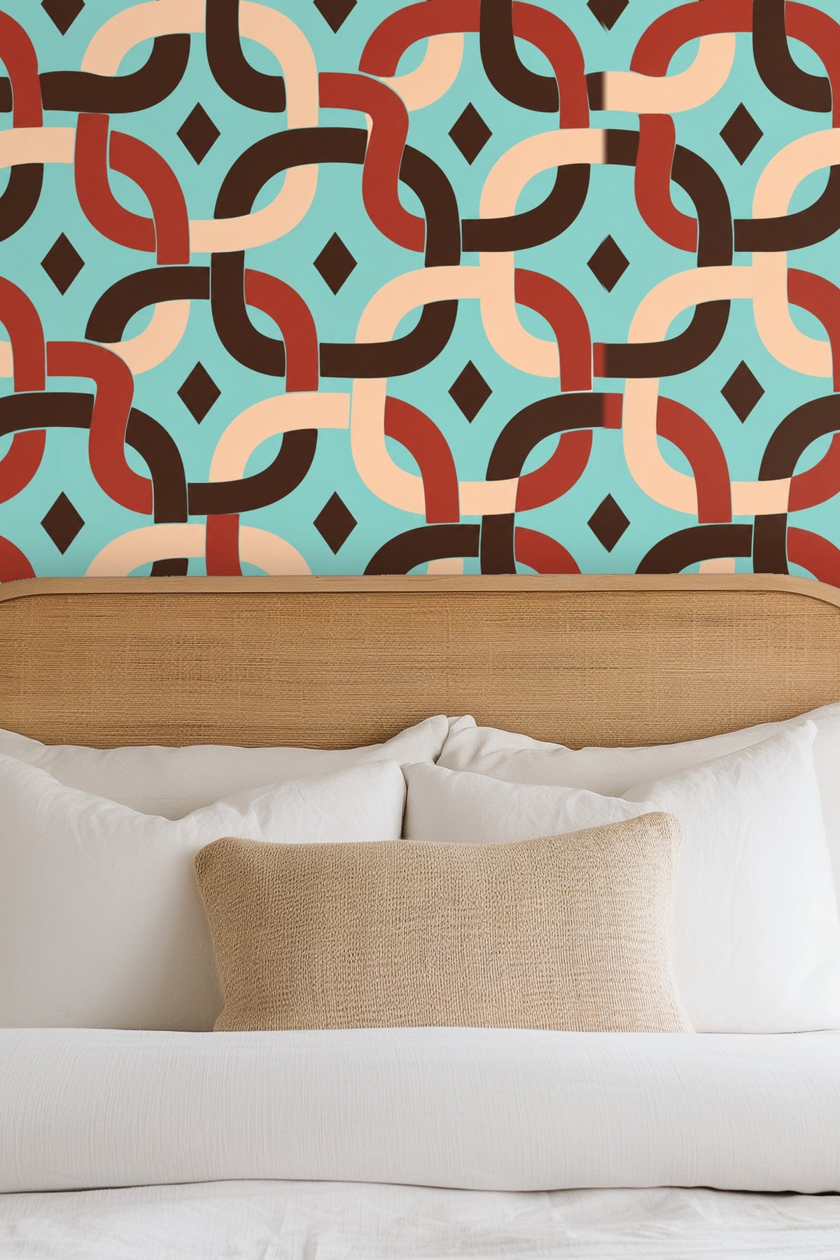 Bedroom wall with tan headboard and white bedding featuring geometric chain wallpaper in aqua, rust, beige, and brown