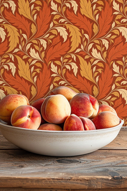 Wallpaper pattern showing broad, curled leaves in warm earth tones on a deep red backdrop.
