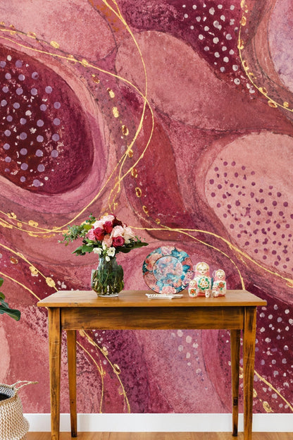 Flowing layered shapes forming an organic mosaic in warm plum and pink