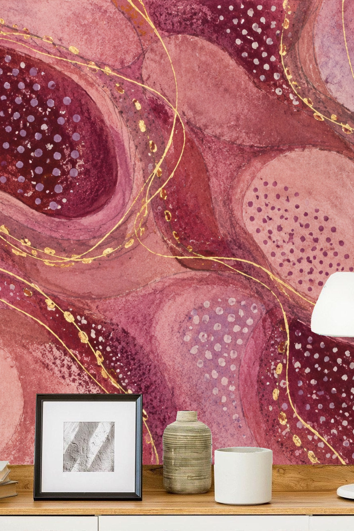 Child's room corner with playful pink and plum abstract wallpaper backdrop and a wooden chair with antler design