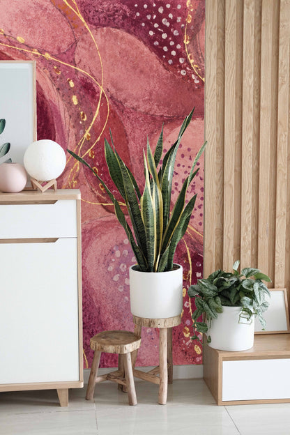 Swirling abstract shapes outlined with gold lines on wallpaper surface