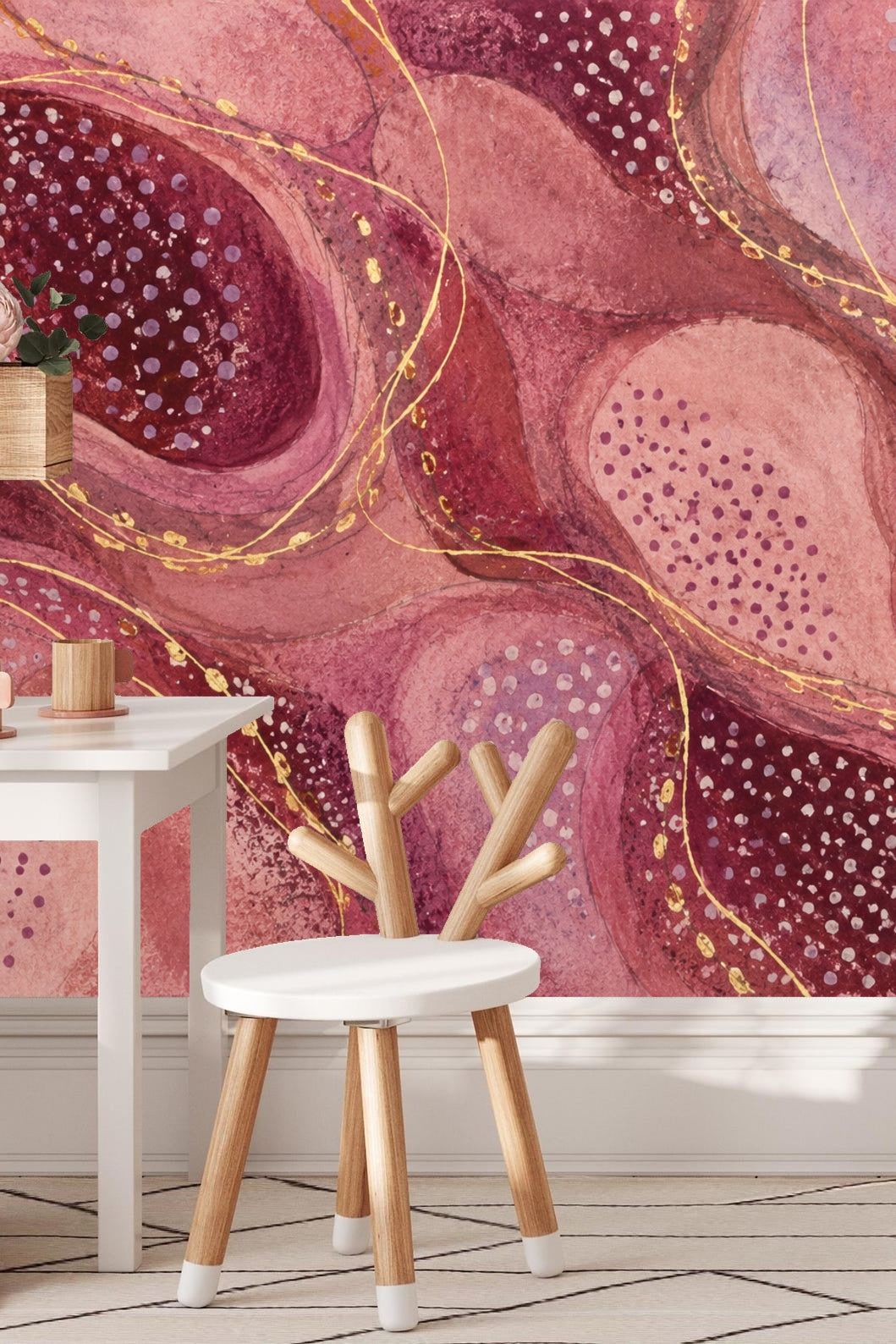 Bedroom wall with deep plum and rosy pink abstract wallpaper behind wooden bedside table and lamp