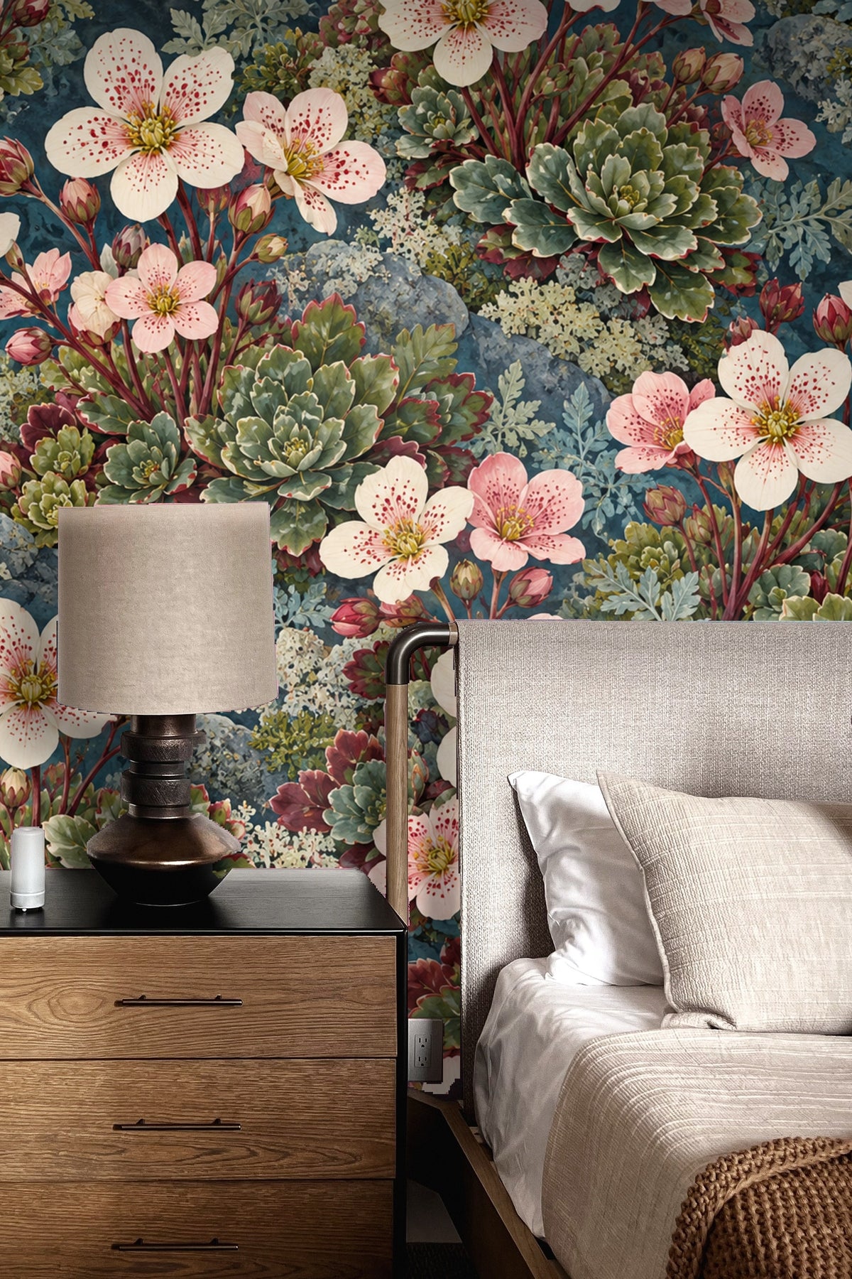 Living room wall featuring floral wallpaper with pale pink wildflowers and green succulents behind white curved sofa