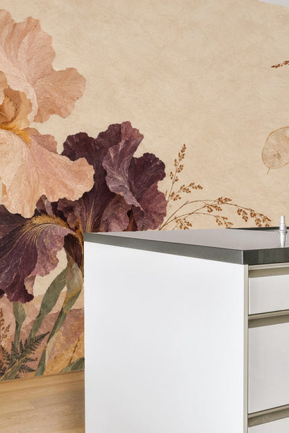 Kids' play corner with large-scale sepia iris wallpaper behind pink bookcase and wicker basket