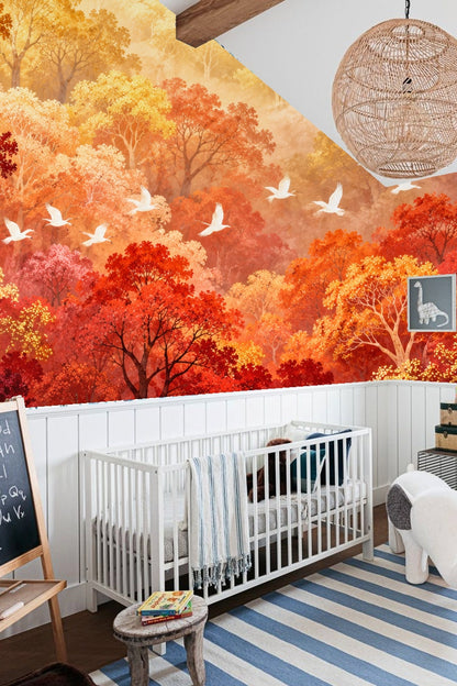 Bedroom with wallpaper showing a vibrant autumn forest with red and orange trees and white birds above a pink and white dresser.
