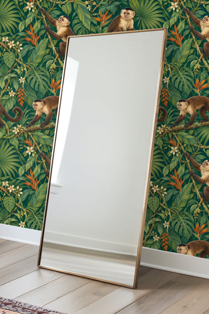 Cluster of orange heliconia flowers and large green leaves on wallpaper