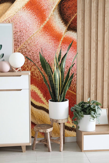 Living room wall with wallpaper and natural wood furnishings.