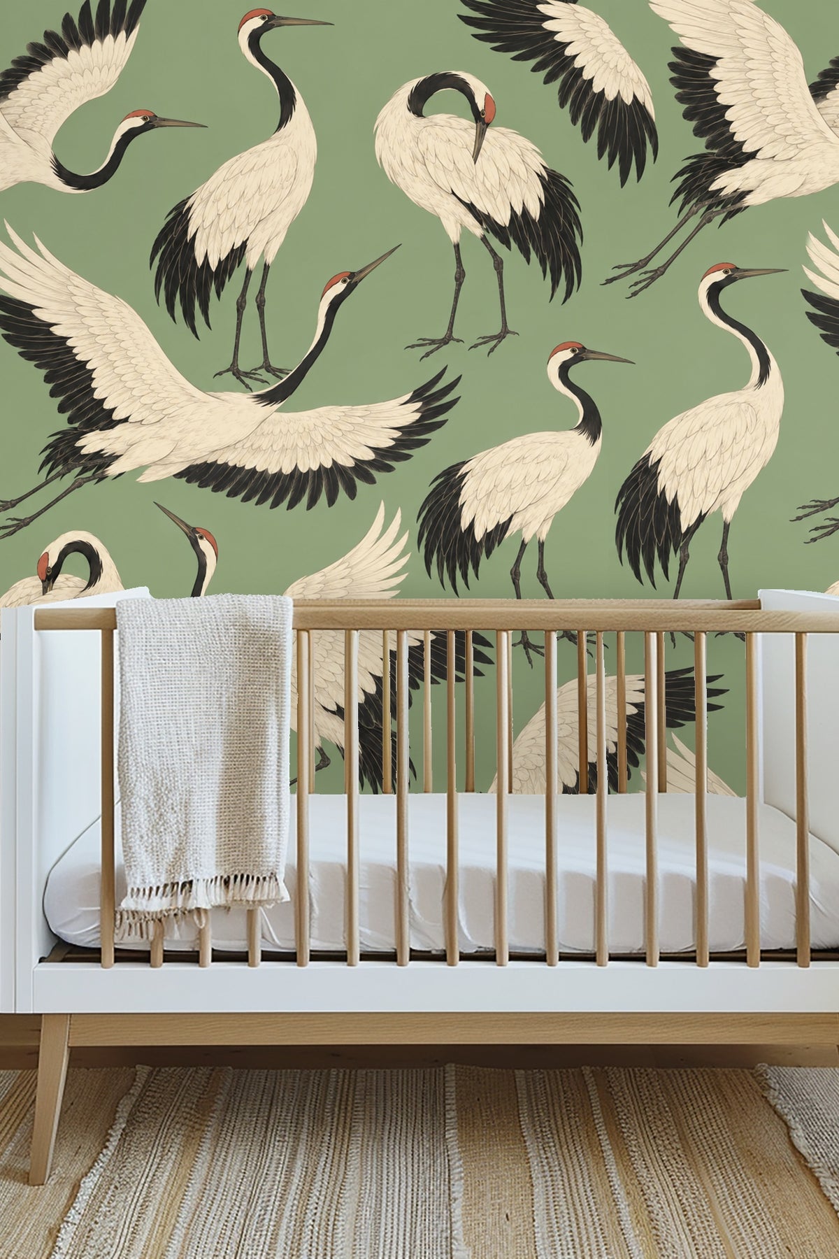 Golden retriever dog lying on a gray cushion in front of sage green crane wallpaper with black and white bird motifs.