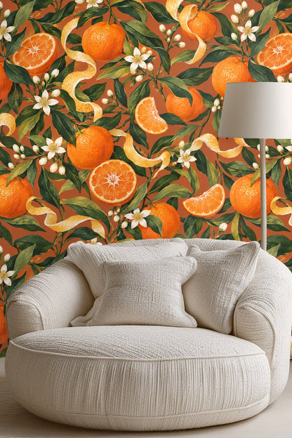 Detailed close-up of botanical orange fruit, leaves, white blossoms and peel on terracotta background