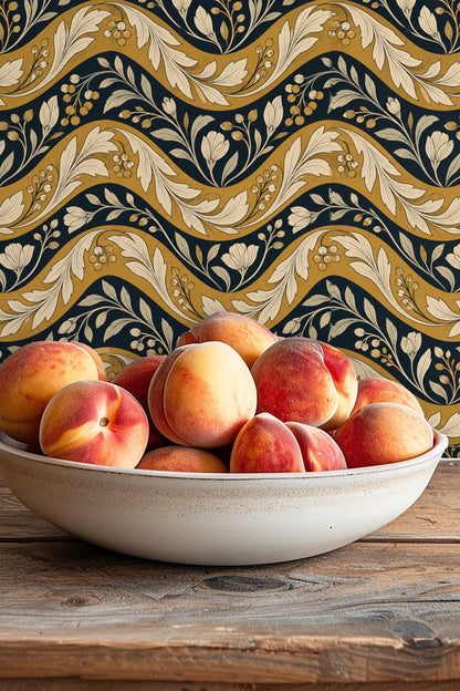 Shelf with natural wood grain complements the wallpaper’s golden waves and creamy foliage.